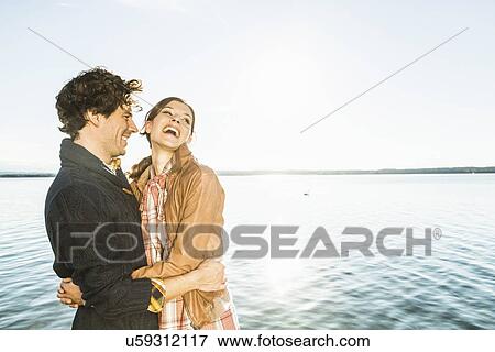 Stock Photo - Couple laughing, Lake Starnberg, Bavaria, Germany. Fotosearch
