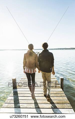 Couple on jetty, Lake Starnberg, Bavaria, Germany View Large Photo Image Stock Image - Couple on jetty, Lake Starnberg, Bavaria, Germany. Fotosearch