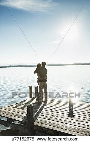 Couple on jetty, Lake Starnberg, Bavaria, Germany View Large Photo Image Stock Photography - Couple on jetty, Lake Starnberg, Bavaria, Germany. Fotosearch