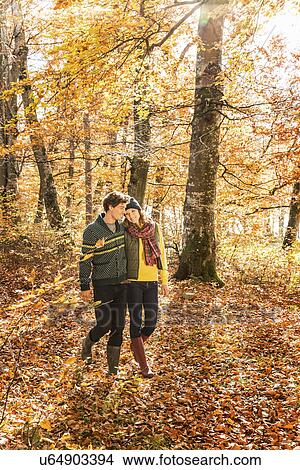 Couple walking in forest View Large Photo Image Picture - Couple walking in forest. Fotosearch
