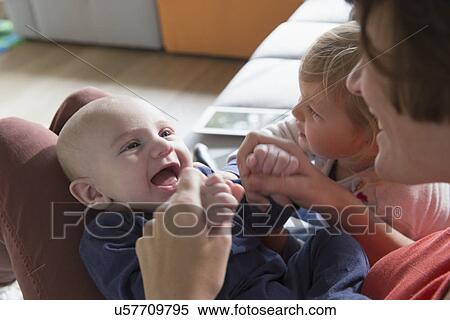 Stock Photography - Cropped shot of mother, baby boy and female toddler. Fotosearch