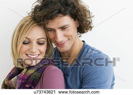Stock Image - Cropped studio shot of loving couple. Fotosearch