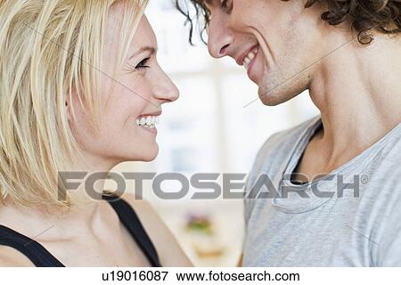 Cropped studio shot of smiling couple View Large Photo Image Stock Photo - Cropped studio shot of smiling couple. Fotosearch