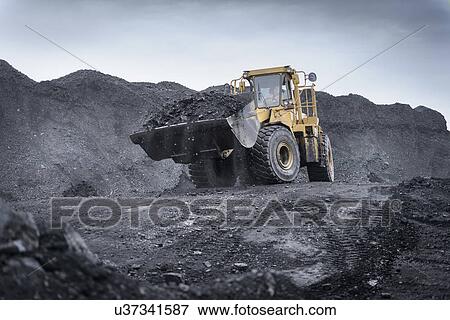 Stock Photo - Digger carrying coal in surface coal mine. Fotosearch