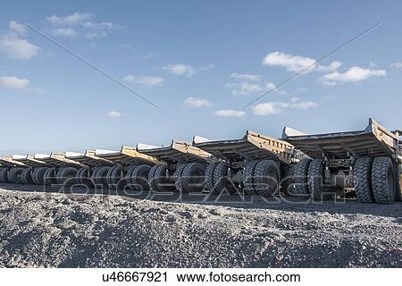Dumper trucks in a row at surface coal mine View Large Photo Image Stock Image - Dumper trucks in a row at surface coal mine. Fotosearch