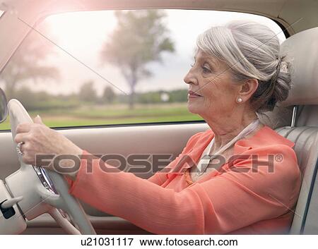 Stock Photo - Elegant senior woman driving in car. Fotosearch