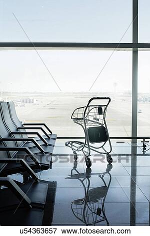 Empty airport departure lounge and suitcase trolley View Large Photo Image Stock Photo - Empty airport departure lounge and suitcase trolley. Fotosearch