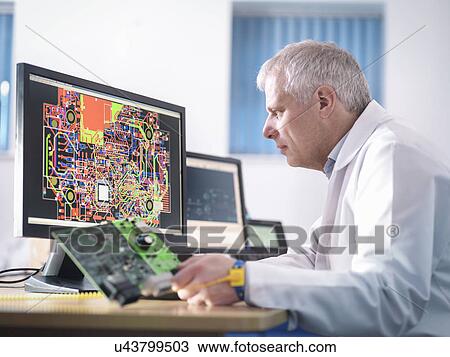 Engineer designing electronic circuitry for automotive use View Large Photo Image Stock Image - Engineer designing electronic circuitry for automotive use. Fotosearch