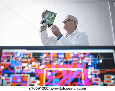 Engineer designing electronic circuitry for automotive use View Large Photo Image Stock Image - Engineer designing electronic circuitry for automotive use. Fotosearch