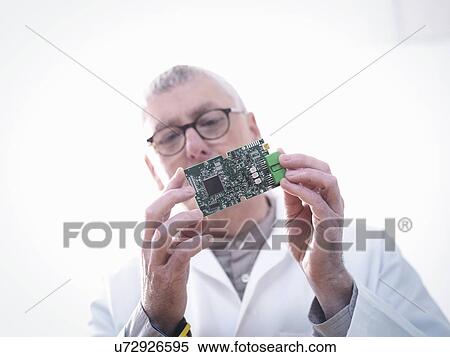 Engineer inspecting electronic circuitry for automotive use View Large Photo Image Stock Photography - Engineer inspecting electronic circuitry for automotive use. Fotosearch