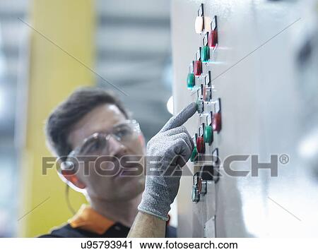 Engineer pressing button in engineering factory View Large Photo Image Stock Image - Engineer pressing button in engineering factory. Fotosearch