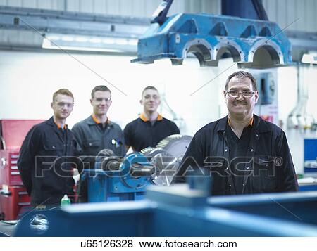 Engineer teaching apprentices in engineering factory, portrait View Large Photo Image Stock Photo - Engineer teaching apprentices in engineering factory, portrait. Fotosearch