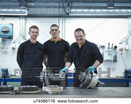 Engineer teaching apprentices in engineering factory, portrait View Large Photo Image Stock Photo - Engineer teaching apprentices in engineering factory, portrait. Fotosearch