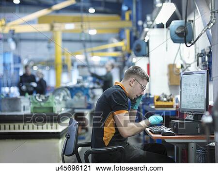 Engineer using telephone and computer in engineering factory View Large Photo Image Stock Image - Engineer using telephone and computer in engineering factory. Fotosearch