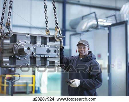 Engineer with industrial gearbox in engineering factory, portrait View Large Photo Image Picture - Engineer with industrial gearbox in engineering factory, portrait. Fotosearch