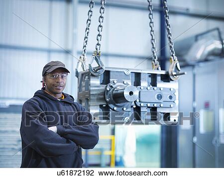 Engineer with industrial gearbox in engineering factory, portrait View Large Photo Image Stock Image - Engineer with industrial gearbox in engineering factory, portrait. Fotosearch