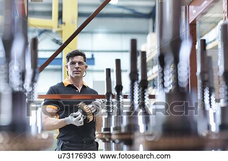 Engineer with parts in industrial gearbox factory, portrait View Large Photo Image Stock Image - Engineer with parts in industrial gearbox factory, portrait. Fotosearch