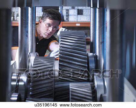 Engineer working on industrial gearbox View Large Photo Image Stock Photography - Engineer working on industrial gearbox. Fotosearch