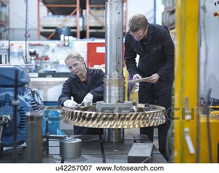 Engineers assembling industrial gearbox in engineering factory View Large Photo Image Stock Photo - Engineers assembling industrial gearbox in engineering factory. Fotosearch