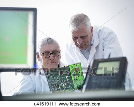 Engineers designing electronic circuitry for automotive use View Large Photo Image Stock Image - Engineers designing electronic circuitry for automotive use. Fotosearch