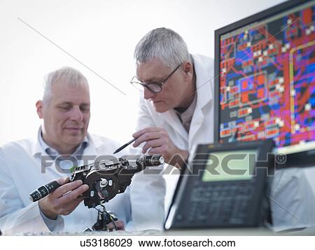 Stock Photo - Engineers designing electronic circuitry for automotive use. Fotosearch