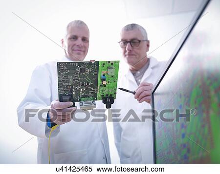 Stock Photography - Engineers designing electronic circuitry for automotive use. Fotosearch
