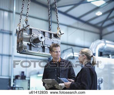 Engineers discuss plans on digital tablet in engineering factory View Large Photo Image Stock Photography - Engineers discuss plans on digital tablet in engineering factory. Fotosearch