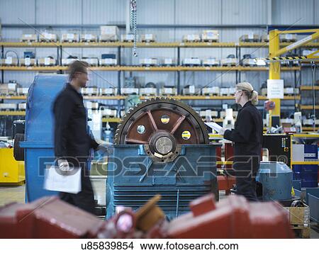 Picture - Engineers repair industrial gearbox in engineering factory. Fotosearch