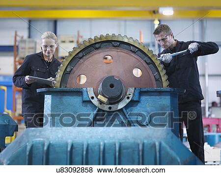 Engineers repair industrial gearbox in engineering factory View Large Photo Image Stock Photo - Engineers repair industrial gearbox in engineering factory. Fotosearch