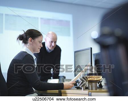 Picture - Engineers using computer aided design in factory office. Fotosearch
