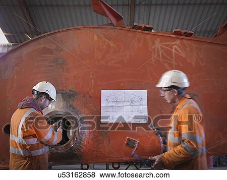 Engineers working on excavator parts in surface coal mine View Large Photo Image Stock Photo - Engineers working on excavator parts in surface coal mine. Fotosearch