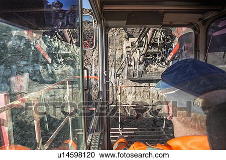 Excavator driver in digger cab at surface coal mine View Large Photo Image Stock Image - Excavator driver in digger cab at surface coal mine. Fotosearch