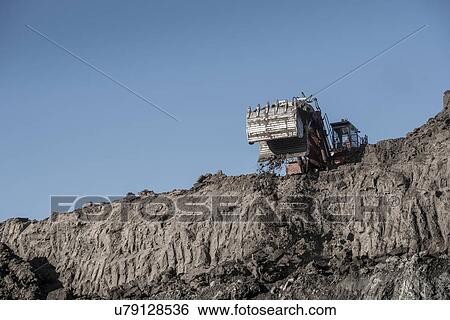 Stock Photograph - Excavator removes glacial deposits at surface coal mine. Fotosearch