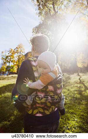 Father carrying baby daughter in carrier View Large Photo Image Stock Image - Father carrying baby daughter in carrier. Fotosearch