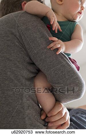 Father carrying baby daughter View Large Photo Image Stock Image - Father carrying baby daughter. Fotosearch