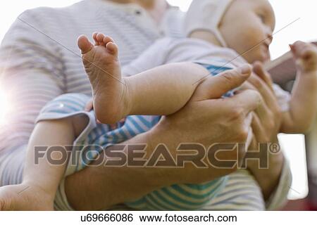 Father carrying baby daughter View Large Photo Image Stock Photograph - Father carrying baby daughter. Fotosearch
