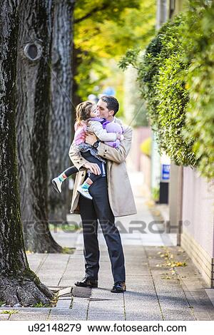 Father carrying daughter on pavement View Large Photo Image Stock Photo - Father carrying daughter on pavement. Fotosearch