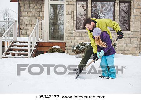 Father helping daughter to shovel snow View Large Photo Image Stock Photo - Father helping daughter to shovel snow. Fotosearch
