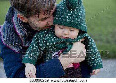 Stock Photo - Father holding baby daughter. Fotosearch