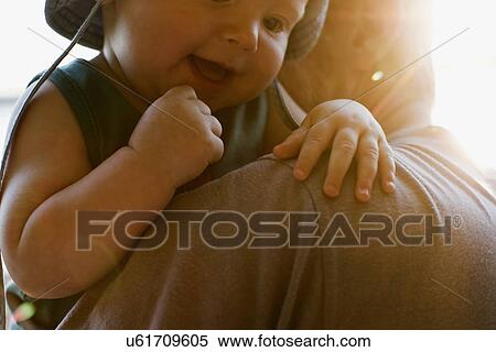Stock Photography - Father holding baby daughter. Fotosearch
