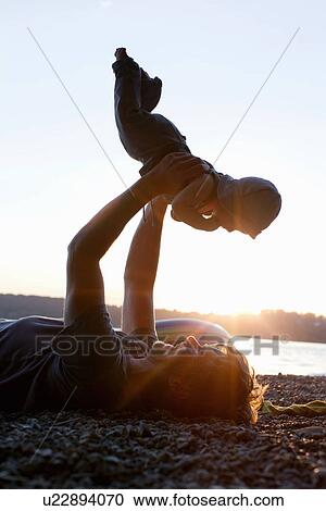 Father lifting baby daughter View Large Photo Image Stock Image - Father lifting baby daughter. Fotosearch