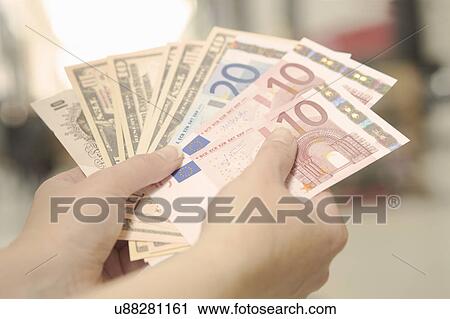 Female hands holding American, British and European bank notes View Large Photo Image Stock Image - Female hands holding American, British and European bank notes. Fotosearch