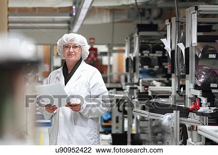 Female scientist holding paperwork in laser laboratory View Large Photo Image Stock Image - Female scientist holding paperwork in laser laboratory. Fotosearch