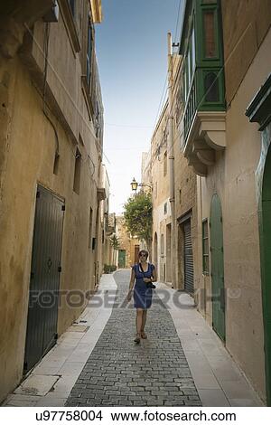 Female tourist walking, Victoria, Gozo, Malta View Large Photo Image Picture - Female tourist walking, Victoria, Gozo, Malta. Fotosearch