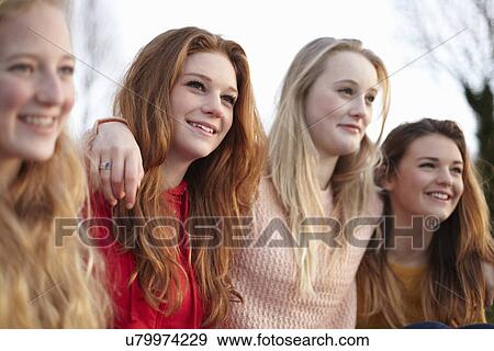 Stock Photo - Four teenage girlfriends posing for portrait. Fotosearch