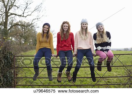 Four teenage girls sitting on gate View Large Photo Image Stock Photography - Four teenage girls sitting on gate. Fotosearch
