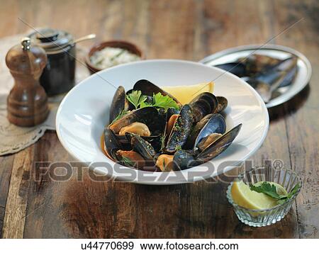 Fresh mussels with garlic, chillies, white wine, parsley and tomato sauce View Large Photo Image Stock Photo - Fresh mussels with garlic, chillies, white wine, parsley and tomato sauce. Fotosearch