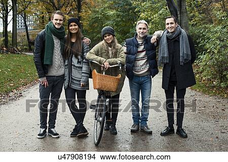 Friends posing with bicycle in woods View Large Photo Image Picture - Friends posing with bicycle in woods. Fotosearch