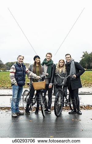 Friends posing with bicycle on street View Large Photo Image Stock Photograph - Friends posing with bicycle on street. Fotosearch