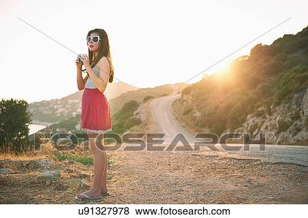 Girl holding camera at sunset, Kas, Turkey View Large Photo Image Stock Photo - Girl holding camera at sunset, Kas, Turkey. Fotosearch